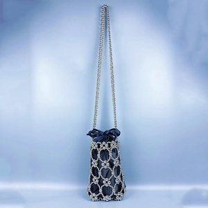 Detail of silver beaded lattice net bucket bag with a blue satin drawstring inner pouch