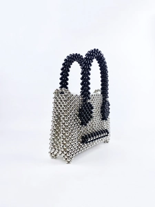 Detail view of handcrafted mini tote featuring silver and black acrylic beaded texture