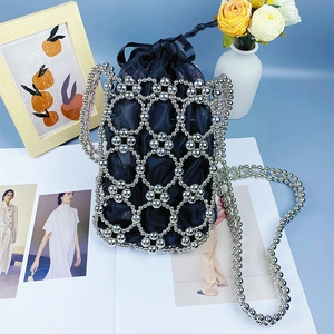 Detail of handmade silver beaded shoulder bag with black drawstring liner and chain strap