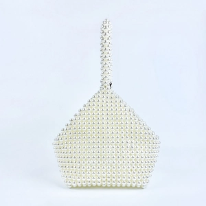 Detailed close-up of the handmade white pearl beaded bag with a unique geometric structure