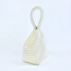 Detail of handmade pearl beaded handbag featuring unique triangular weave and smooth texture
