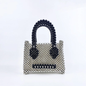 Detail of beaded mini handbag featuring a silver and black pearl expression pattern