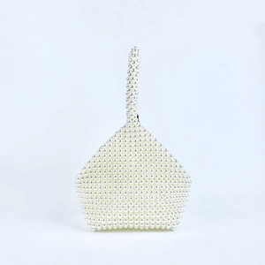 Detailed view of handmade beaded pearl handbag with unique pentagonal woven structure