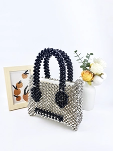 Handmade silver and black beaded handbag with a pearl-like finish and top handle