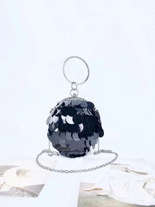 Detail of a black sequined spherical evening bag with a crystal-encrusted metal handle