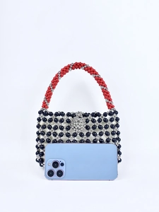 Detailed view of handmade beaded tote bag next to a smartphone for scale reference
