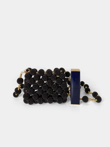 Mini handmade black beaded evening bag with gold chain and clasp on white background