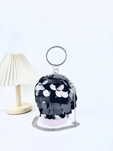 Detail of black sequin ball clutch with sparkling rhinestone handle and silver chain strap