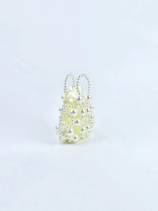 Detail of beaded pearl handbag showing woven texture and satin lining for party wear