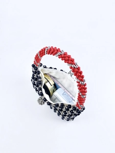 Macro view of handmade beaded bag interior showing storage space for phone and makeup