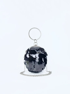 Detailed view of spherical evening bag with black sequins and rhinestone handle
