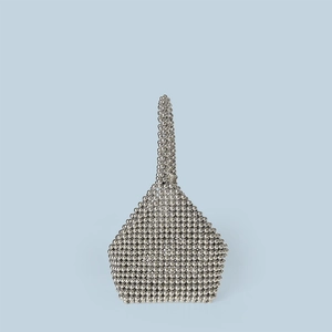 Detailed close-up of handmade silver beaded handbag with unique geometric triangular texture