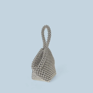 Detailed close-up of handmade silver beaded mini handbag with textured weaving