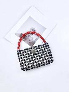 Handmade beaded handbag with black and silver geometric patterns and a floral lock