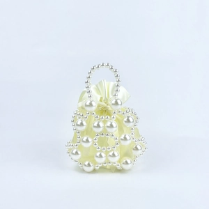 Close-up of handmade beaded handbag with cream satin drawstring lining and pearl handle