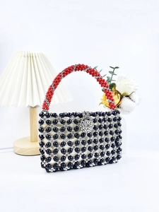 Handmade woven beaded handbag with red handles and black silver geometric patterns