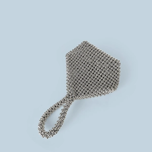 Detail of silver beaded handbag showing textured metal beads and circular ring handle