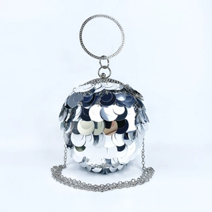 Detail of silver spherical evening bag with large sequins and rhinestone ring handle