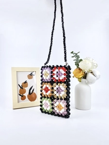 Handmade colorful acrylic beaded crossbody bag with floral patterns and black strap