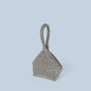 Detail of silver beaded handmade handbag with unique triangular geometric weave structure
