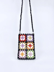 Handmade beaded crossbody bag with colorful rainbow flower patterns on a black base