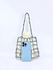 Detail of silver beaded mesh bag with satin drawstring liner and smartphone for scale