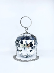 Detail of silver spherical evening bag with sequins and rhinestone handle for parties