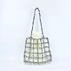 Detail of silver beaded handbag with white satin drawstring liner and woven metallic beads