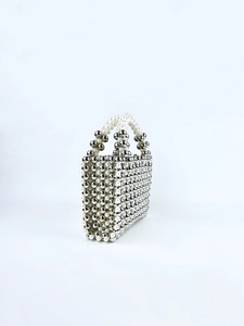 Close-up of handmade acrylic bead bag with silver metallic and pearl checkered pattern
