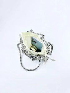 Detailed top view of handmade silver beaded handbag with satin drawstring lining