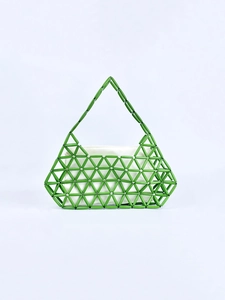 Detailed view of green beaded handbag with geometric hollow mesh and white inner bag
