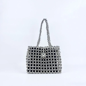Macro shot of silver hollowed beaded bag with intricate handmade pearl textures