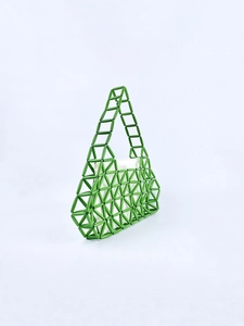 Detailed view of green beaded handbag featuring a geometric triangle weave and white inner lining