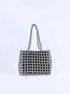 Detail of silver beaded handbag showing intricate grid weaving and black fabric lining