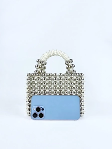Detail of handmade square beaded handbag with silver metal beads and white pearls