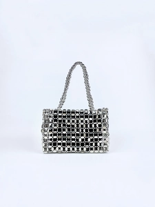 Detail of silver metallic disc handbag with reflective scales and beaded handles