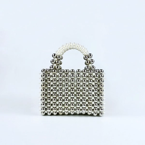 Detail of handmade square beaded handbag with metallic silver beads and white pearls