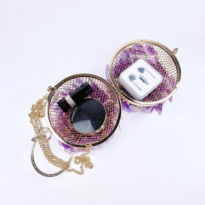 Detailed interior view of spherical sequin evening bag showing storage for small items