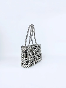 Detail of silver metallic disc chainmail bag with intricate handcrafted beadwork
