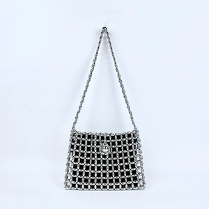 Detailed view of silver beaded shoulder bag featuring hollow woven pattern and black inner pouch