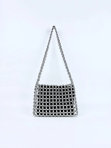 Close-up of silver beaded woven shoulder bag with intricate mesh pattern and black lining