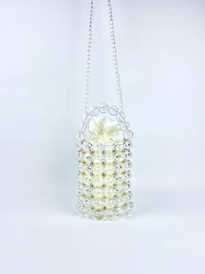Detail of handmade beaded barrel bag with transparent acrylic beads and satin pouch