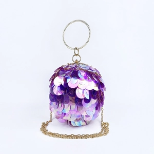 Detailed macro of a purple sequined sphere evening bag with a gold rhinestone handle