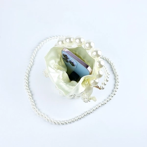 Top view of handmade pearl bucket bag showing internal capacity for a smartphone