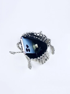 Interior view of silver beaded handbag showing capacity for phone and cosmetics