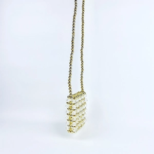 Detail of handmade beaded mini bag featuring golden metal beads and faceted crystal texture