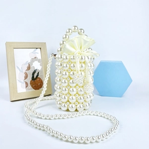 Detail of handmade pearl beaded bucket bag with cream satin drawstring lining