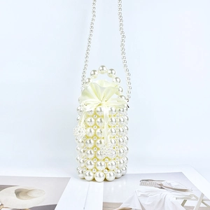 Detail of handmade pearl bucket bag with satin drawstring pouch and bow closure