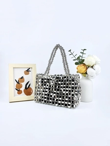 Chic silver hollow metal disc beaded handbag with a modern retro industrial design