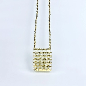 Detail of handcrafted gold and clear beaded mini crossbody bag with luxury texture